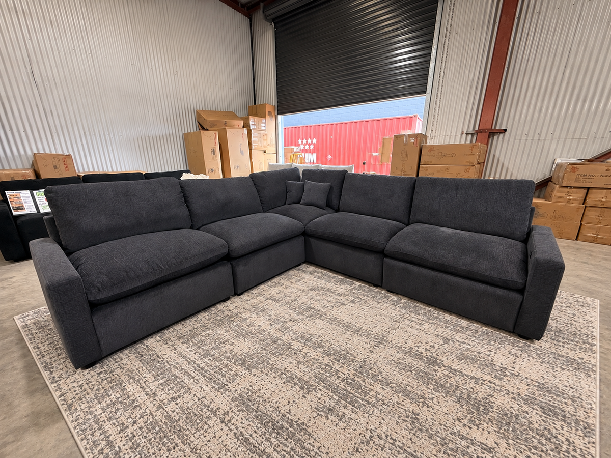 Luxury charcoal corner lounge with generously filled cushions and spacious seating