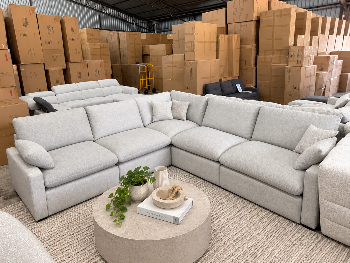 Spacious plush fabric corner sofa in light grey with comfortable sectional seating