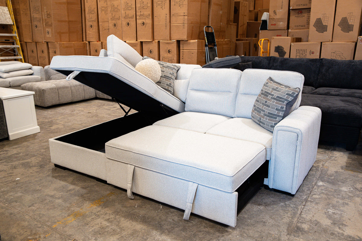 Light grey corner lounge with pull-out sofa bed extended for relaxing